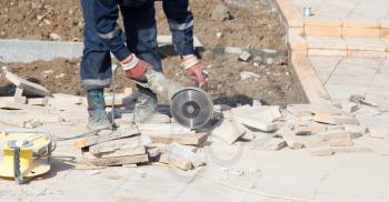 Worker cuts paving slabs