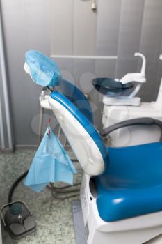 Blue chair for dentists in the clinic .