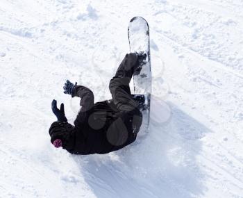 Snowboarder fell in the snow at speed .