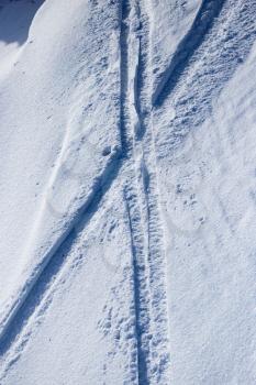 Traces of skis on snow as background .