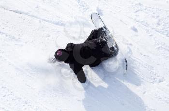 Snowboarder fell in the snow at speed .