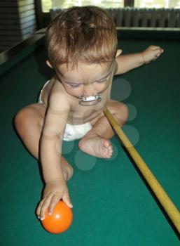 Little boy playing snooker