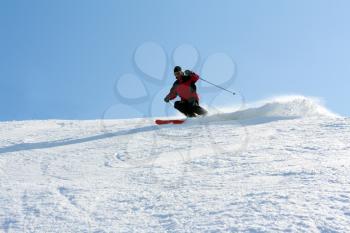 Royalty Free Photo of a Man Skiing Down a Mountain