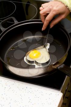 Royalty Free Photo of a Person Making an Egg