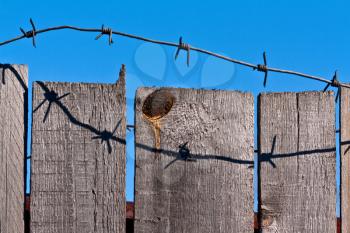 Royalty Free Photo of a Fence With Barbed Wire