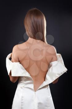 Royalty Free Photo of a Woman Undressing From a Wedding Dress