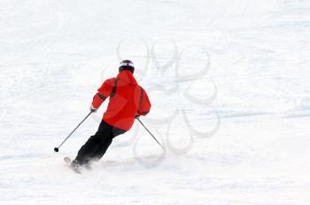 Man skiing in the orange jacket leaves