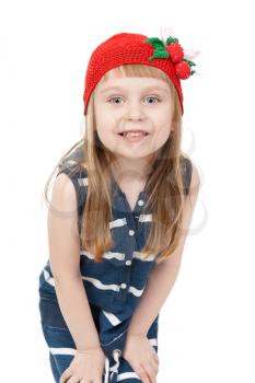 a charming little girl in the red cap looks into the camera. Isolate on white