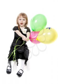 A little girl of four years of age with balloons. Isolate on white