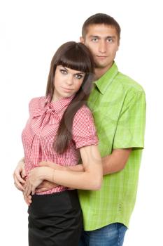 Young couple in a plaid colored clothes hug on white in studio.