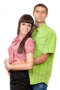 A man in a green plaid shirt hugs a beautiful brunette girl in a red plaid shirt. Family portrait on a white background.