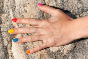 Female hand with colorful trendy manicure in stone