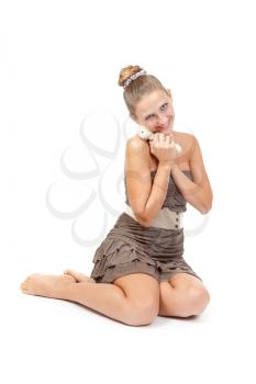 Beautiful girl with a teddy bear sitting on the floor. Isolate on white background.