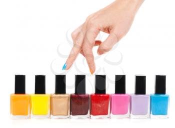 Female hand fingers are the colored paints polish on a white background