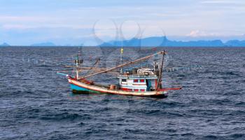 Thai fishing schooner at sea in bad weather conditions