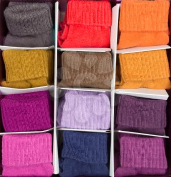 box of colored socks in cells