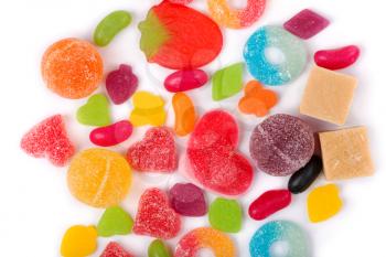 An assortment of colorful candy on background with jellybeans, gumdrops and other jelly candies