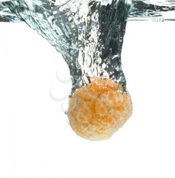 Peeled mandarin orange falls in water leaving the water splashes