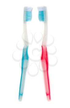A blue and a red toothbrush isolated on white background.