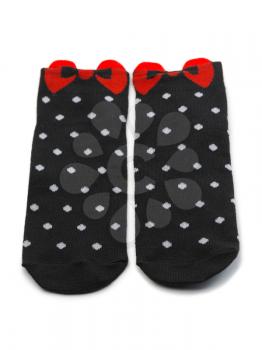 Pair of black socks with white polka dots with a red bow. Isolate.