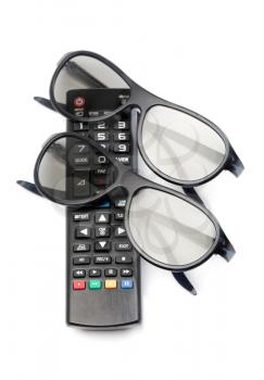 Two pairs of 3D glasses and remote control TV. Isolate on white background.