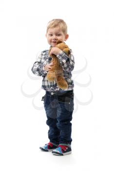 The three-year boy with a toy bear isolated on white background.