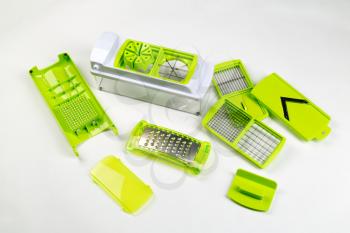 Green Plastic range of vegetable slicers on a light background.