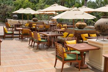 Empty restaurant with umbrellas in tropics