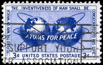 Royalty Free Photo of 1955 US Stamp Shows the Atomic Energy Encircling the Hemispheres, Atoms for Peace Policy