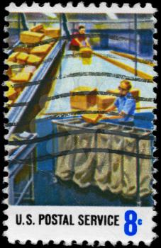 Royalty Free Photo of 1973 US Stamp Shows the Parcel Post Sorting, Postal Service Employees
