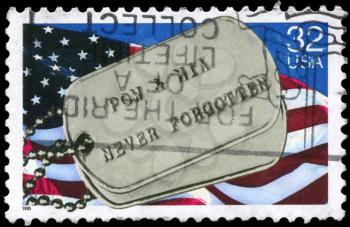 Royalty Free Photo of 1995 US Stamp Shows the US Flag and Military Badge, With the Words Prisoners of War and Missing in Action Never Forgotten