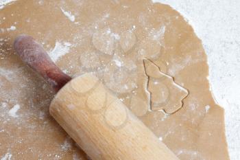Royalty Free Photo of a Rolling Pin on Cookie Dough