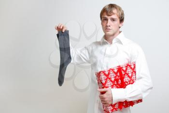 Royalty Free Photo of a Man Holding a Present and a Sock