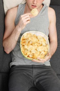 Royalty Free Photo of a Man Eating Potato Chips