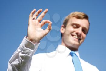 Royalty Free Photo of a Businessman Making the Okay Sign