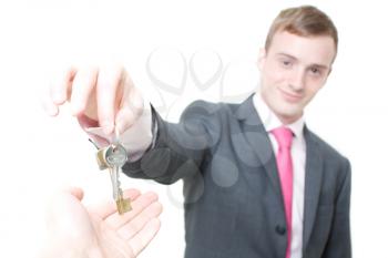 Royalty Free Photo of a Businessman Giving a Person Keys