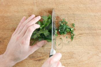 Royalty Free Photo of a Person Cutting Parsley