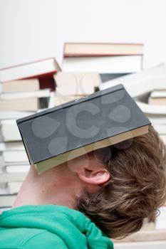 Royalty Free Photo of a Man Sleeping With a Book on His Face