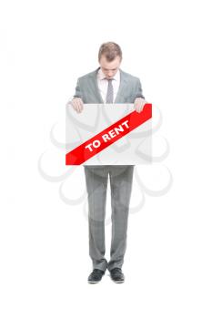 Royalty Free Photo of a Businessman Holding a To Rent Sign