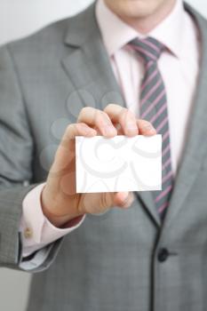 Royalty Free Photo of a Businessman Holding a Card
