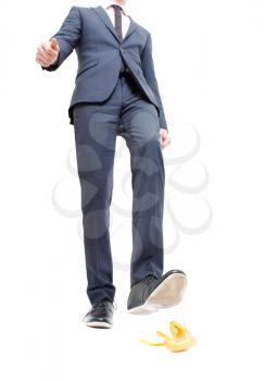 Royalty Free Photo of a Businessman Stepping on a Banana Peel