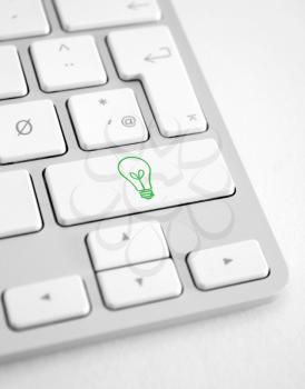 Royalty Free Photo of a Light Bulb Button on a Keyboard