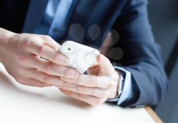 Royalty Free Photo of a Businessman Texting