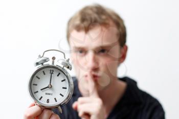 Royalty Free Photo of a Man Holding an Alarm Clock