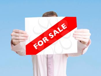 Royalty Free Photo of a Man Holding a For Sale Sign