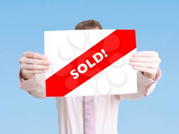 Royalty Free Photo of a Person Holding a Sold Sign