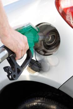 Royalty Free Photo of a Man Putting Gas Into His Car