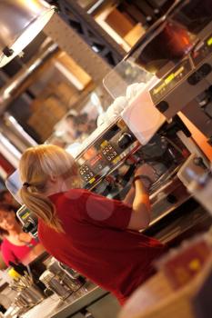 Royalty Free Photo of a Woman Using an Espresso Machine