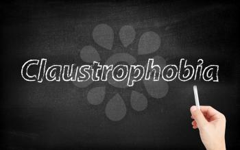 Claustrophobia written on white blackboard