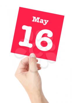 May 16 written on a card held by a hand